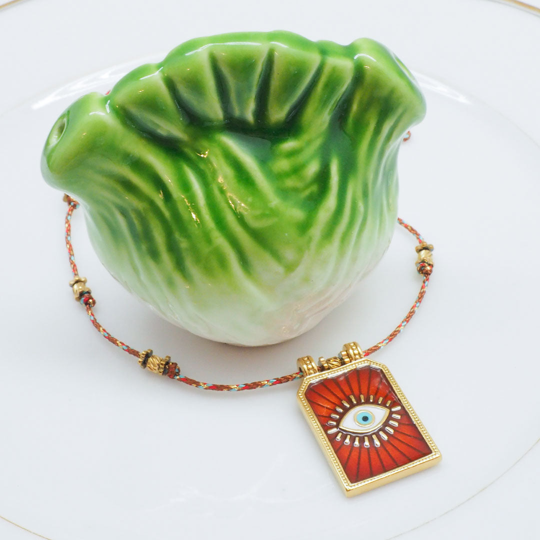 COLLIER LARIÑO - MÉDAILLE OEIL SUR CORDON TRESSÉ