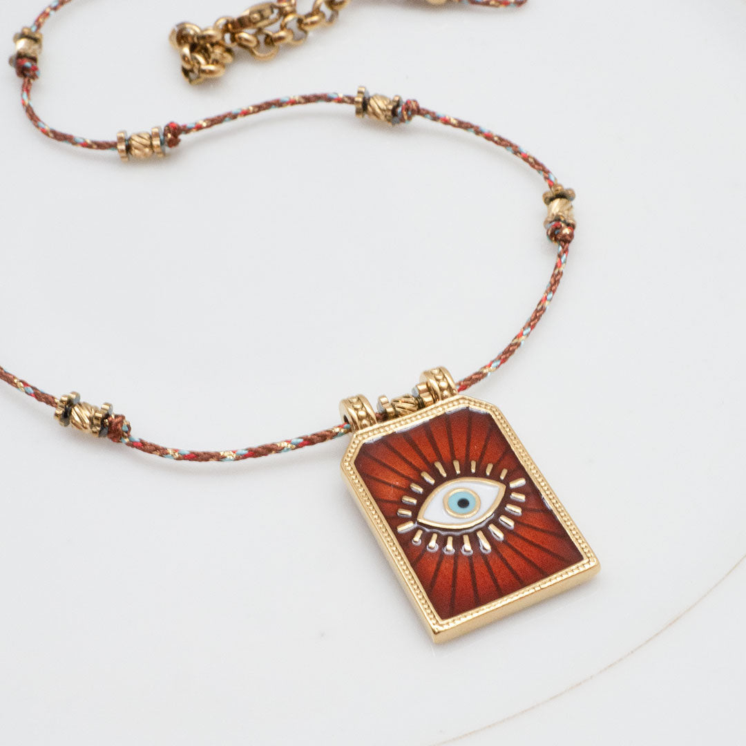 COLLIER LARIÑO - MÉDAILLE OEIL SUR CORDON TRESSÉ